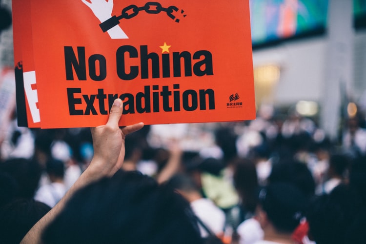 Person holding a No China Extradition sign.