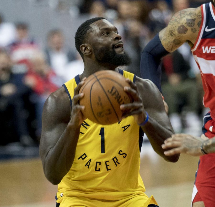 Lance Stephenson going up for a contact layup against a Wizards player.