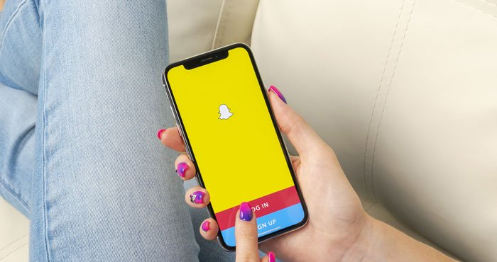 This iPhone screen shows someone logging into Snapchat. 